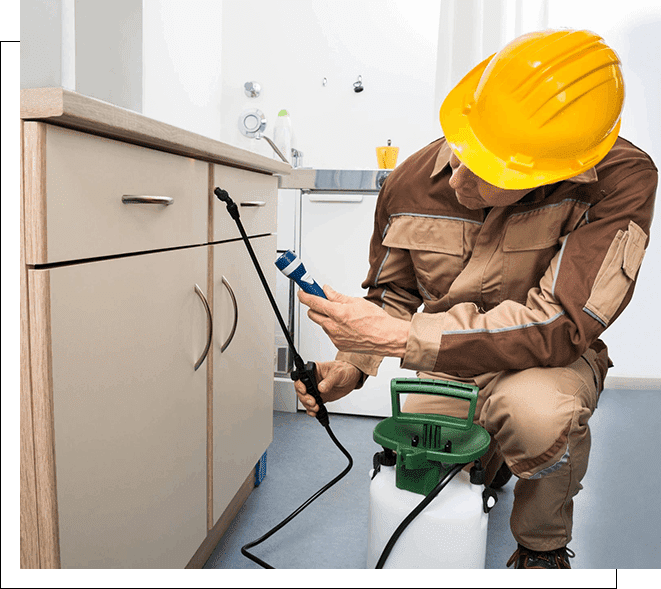 A man in brown work suit and yellow hard hat working on a green hose.